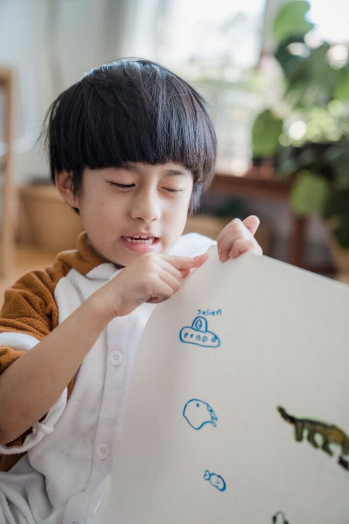 A young child in a cozy living room proudly showing his drawings, fostering creativity and learning.